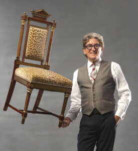 photo of Charles Pavarini III with a chair on his finger